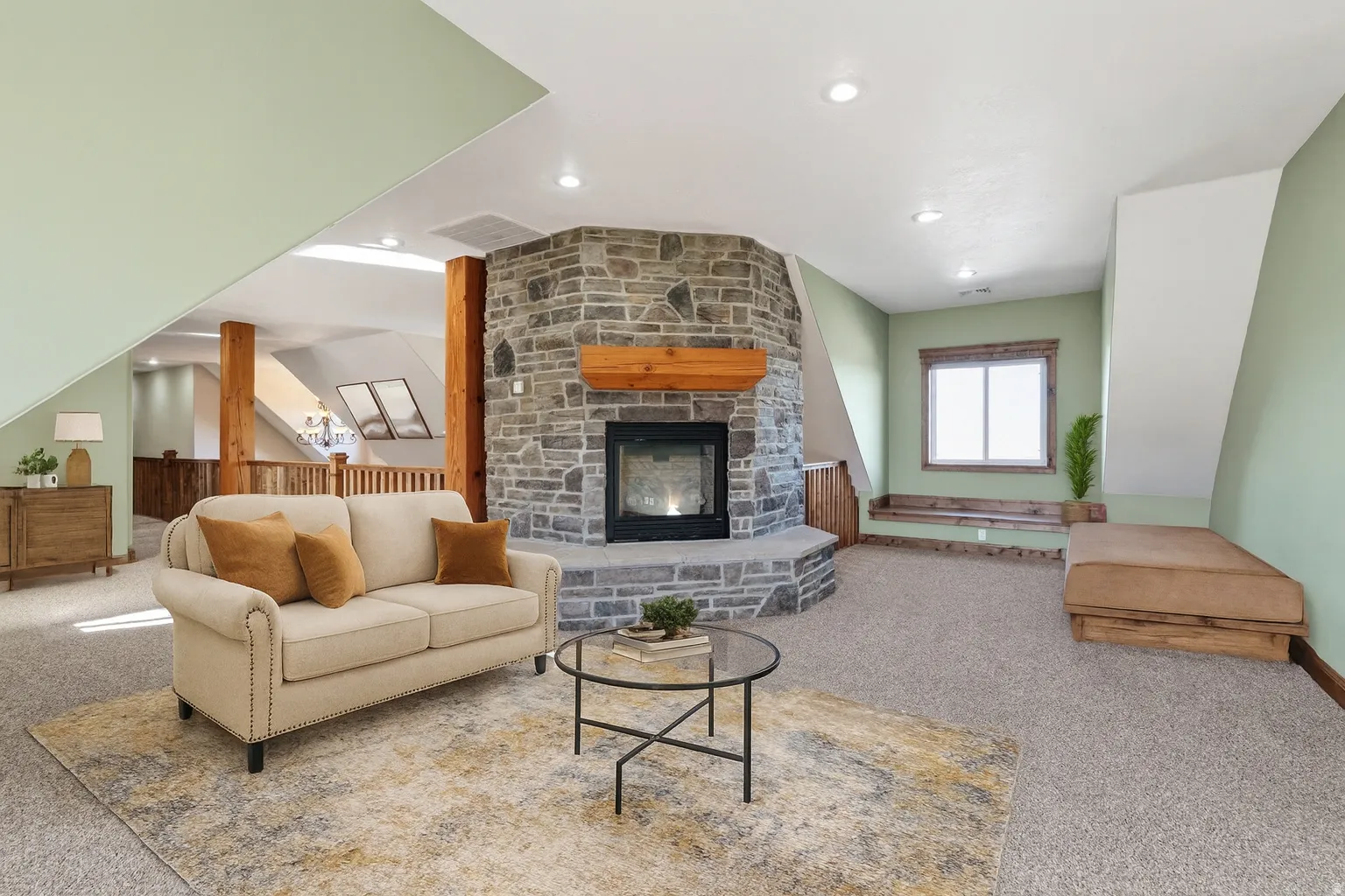Carpeted living area with a stone fireplace and recessed lighting