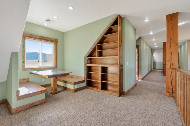Bonus room with light colored carpet, recessed lighting, and a mountain view