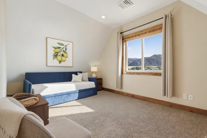 Bedroom with vaulted ceiling, carpet floors, a mountain view, and recessed lighting
