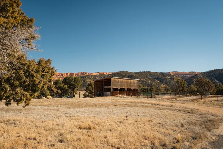 View of yard featuring an outdoor structure, a view of countryside, an outbuilding, and a mountain view