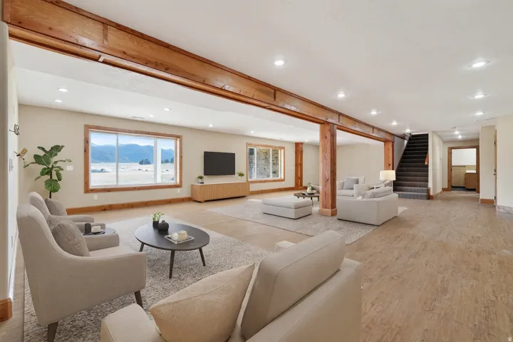 Living room featuring light wood-style floors, stairs, and recessed lighting