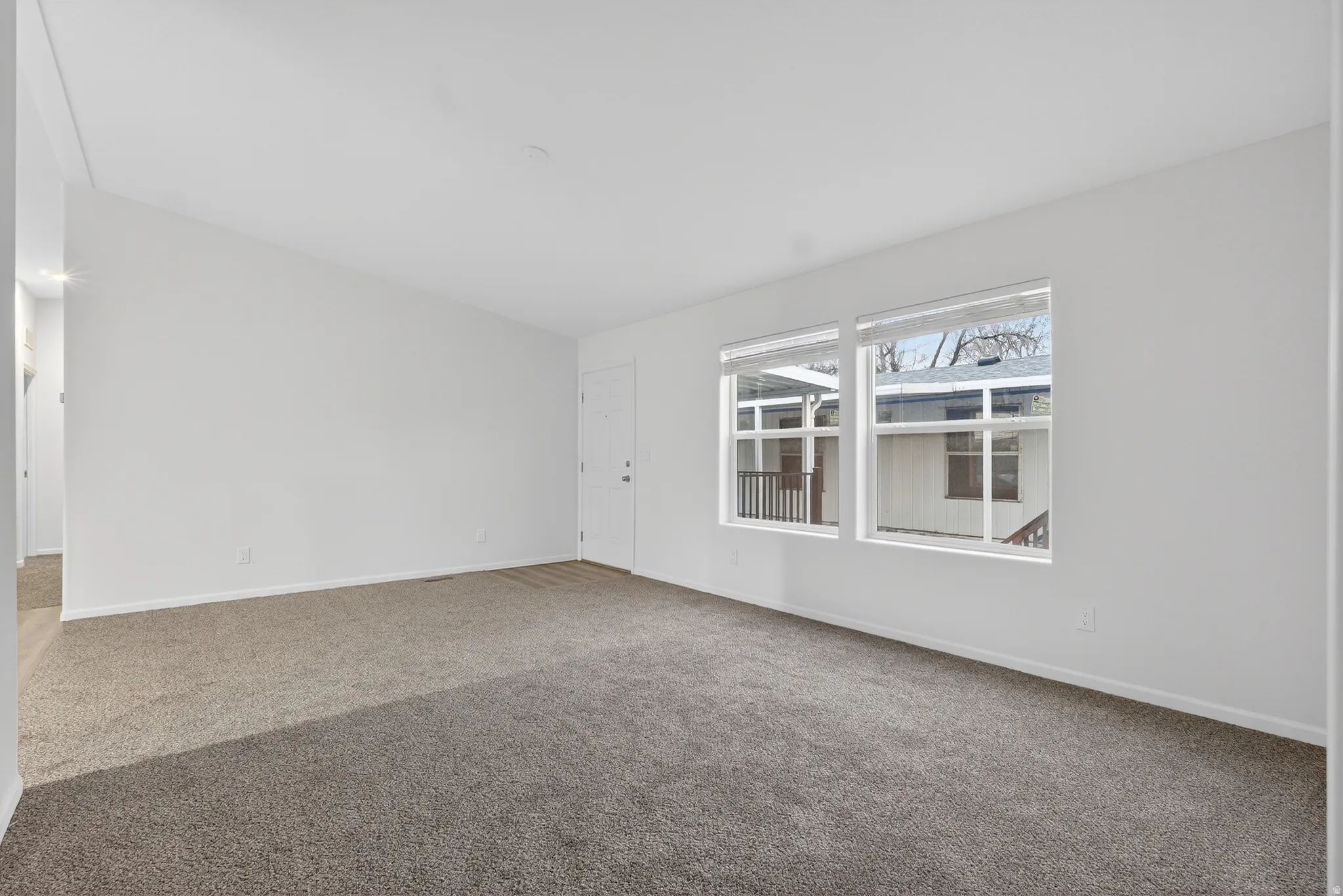 Unfurnished room featuring carpet flooring and baseboards
