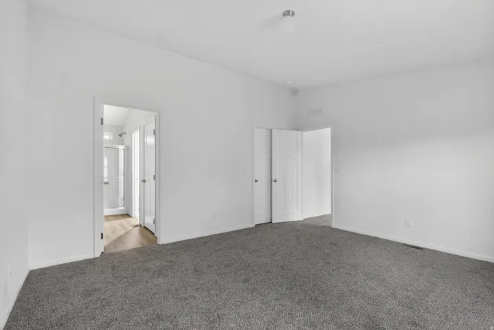 Unfurnished room featuring carpet flooring and baseboards