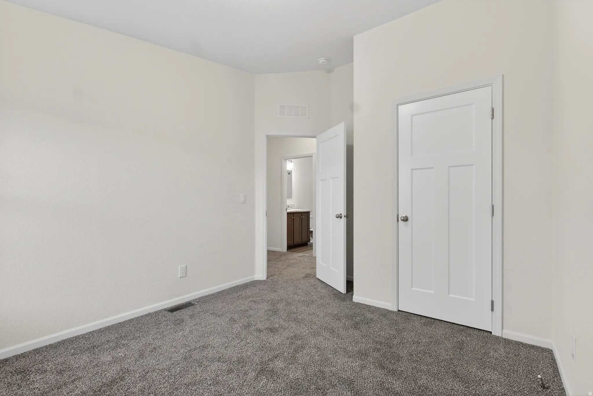 Unfurnished bedroom featuring carpet floors and baseboards