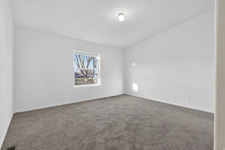 Unfurnished room with carpet floors and baseboards