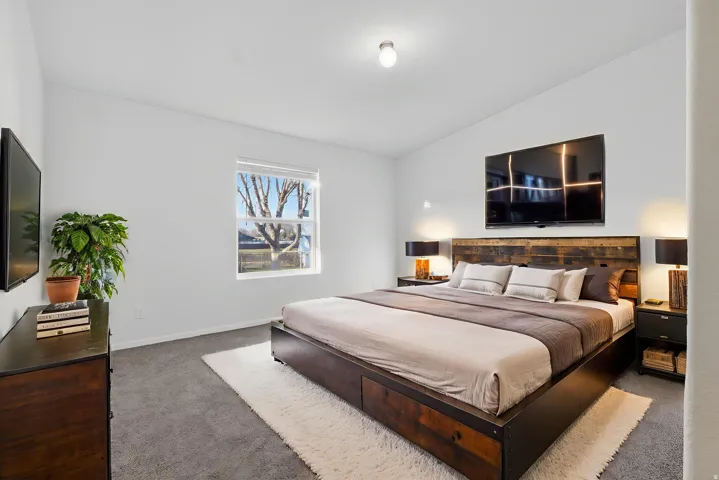 *Virtually staged* Bedroom with carpet floors and lofted ceiling