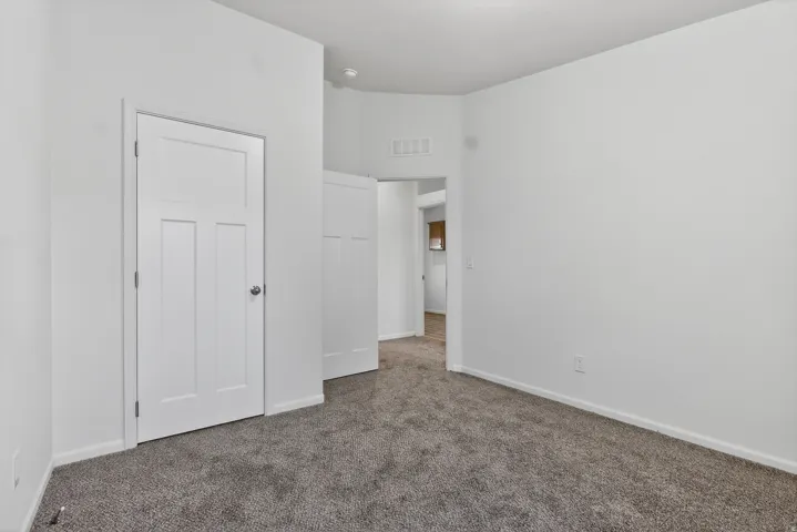 Unfurnished bedroom featuring carpet floors and baseboards