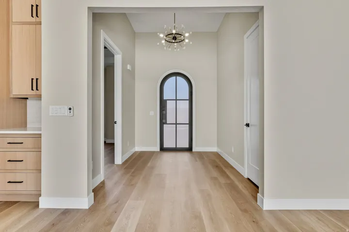 Foyer featuring a chandelier and light wood-type flooring