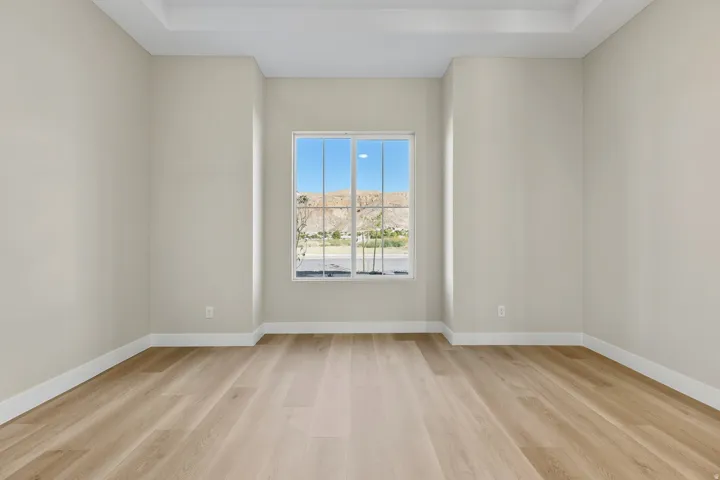 Empty room with light wood finished floors