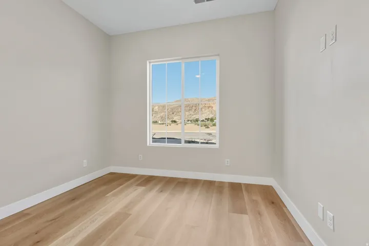 Unfurnished room featuring baseboards and light wood-type flooring