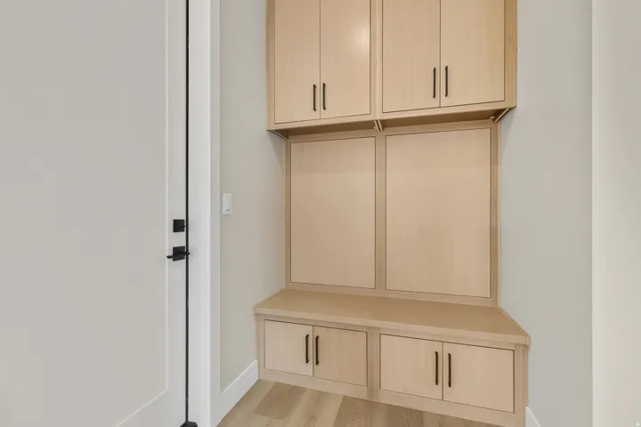 Mudroom with light wood-type flooring and baseboards