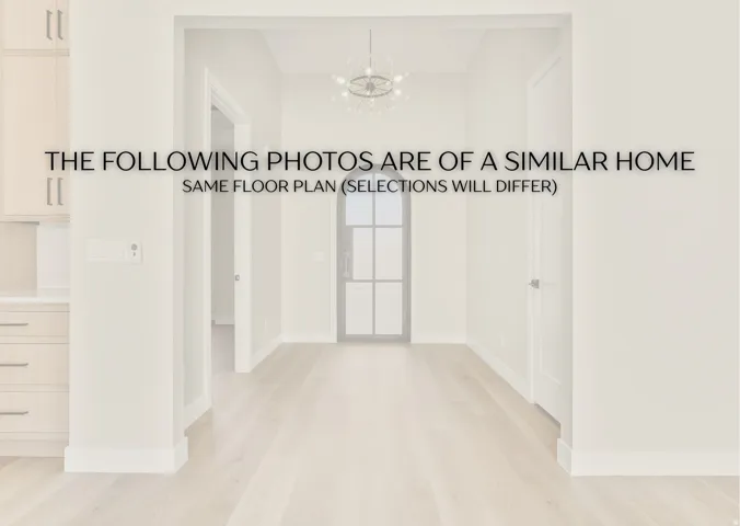 Hallway with light wood-style flooring and a chandelier