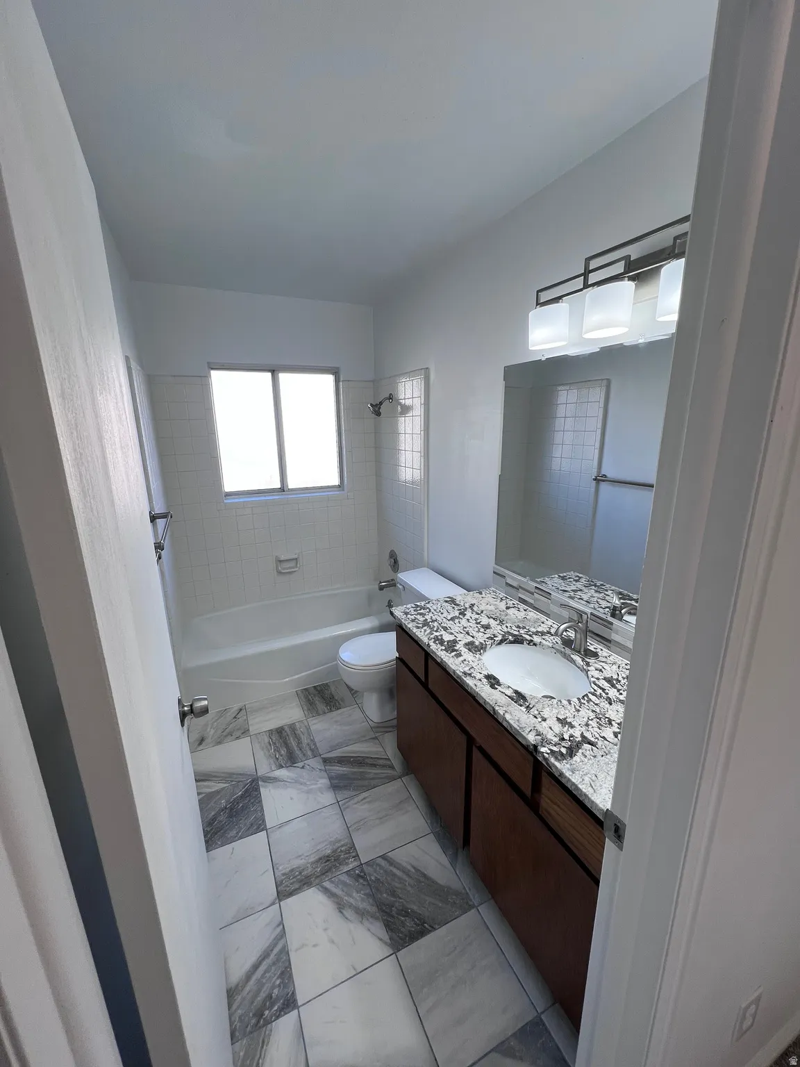 Full bath with bathing tub / shower combination and vanity