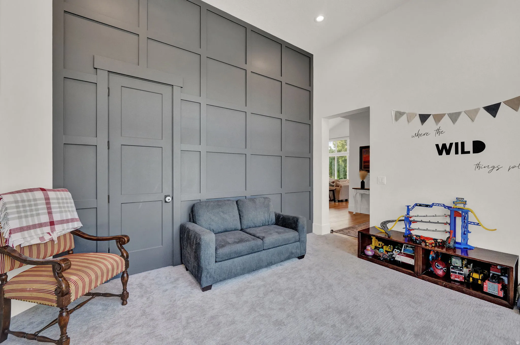 Living area featuring carpet flooring, a high ceiling, and recessed lighting