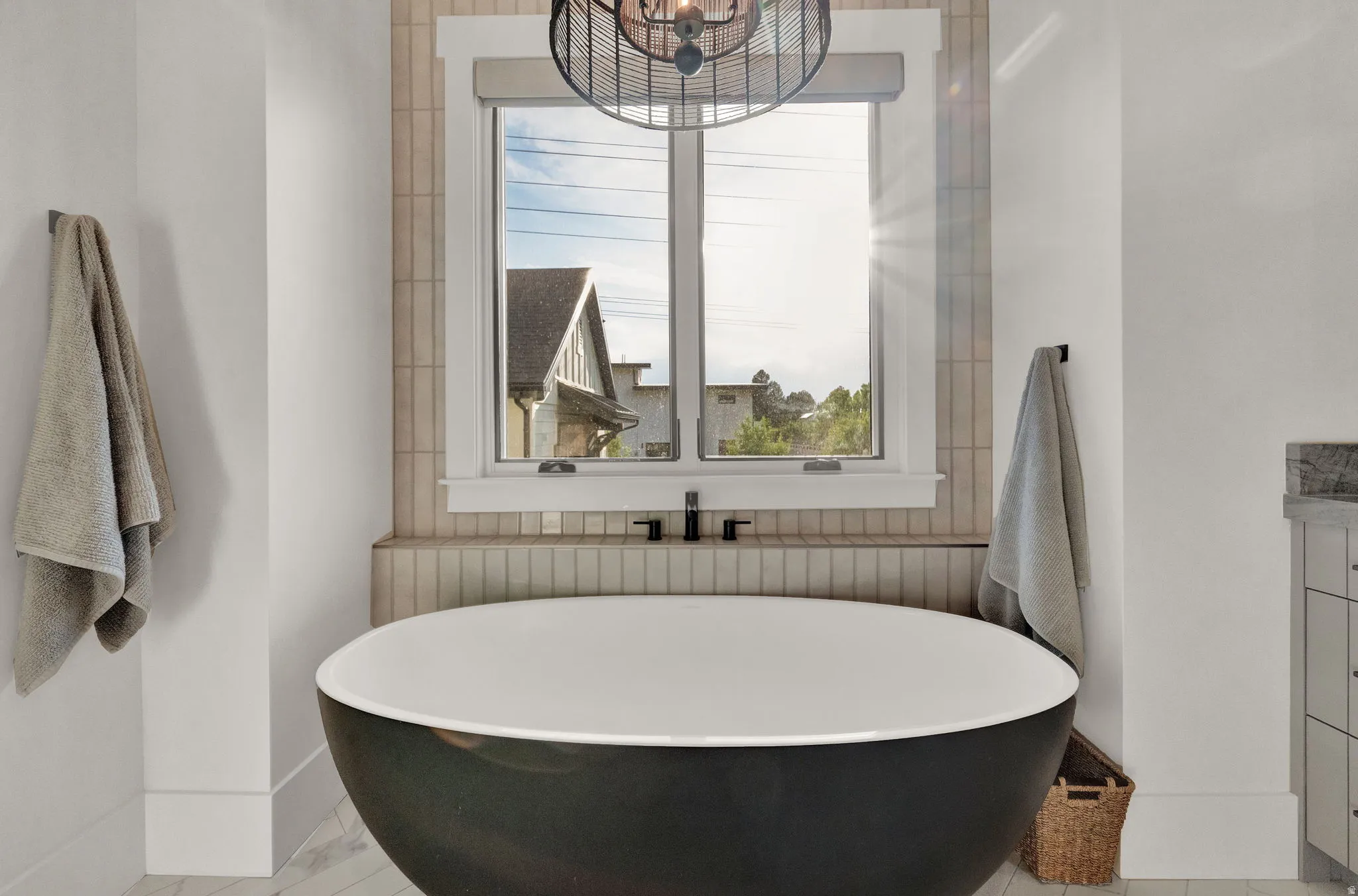 Bathroom with a freestanding tub and baseboards