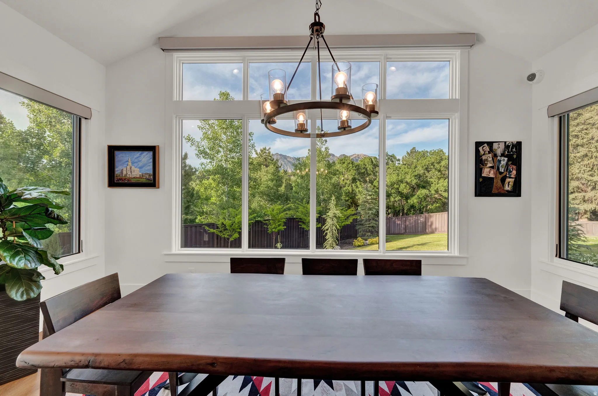 Unfurnished dining area with vaulted ceiling, plenty of natural light, and a chandelier