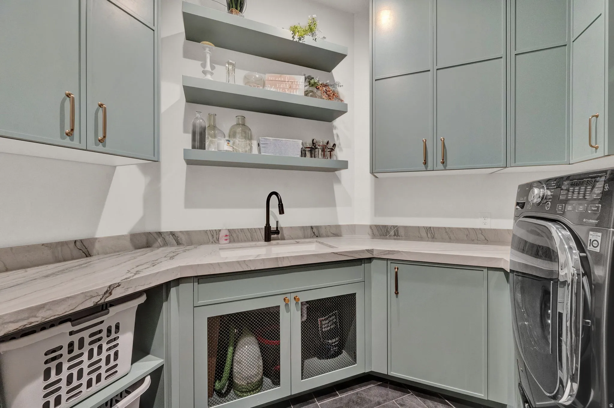 Laundry area featuring washer / clothes dryer and cabinet space
