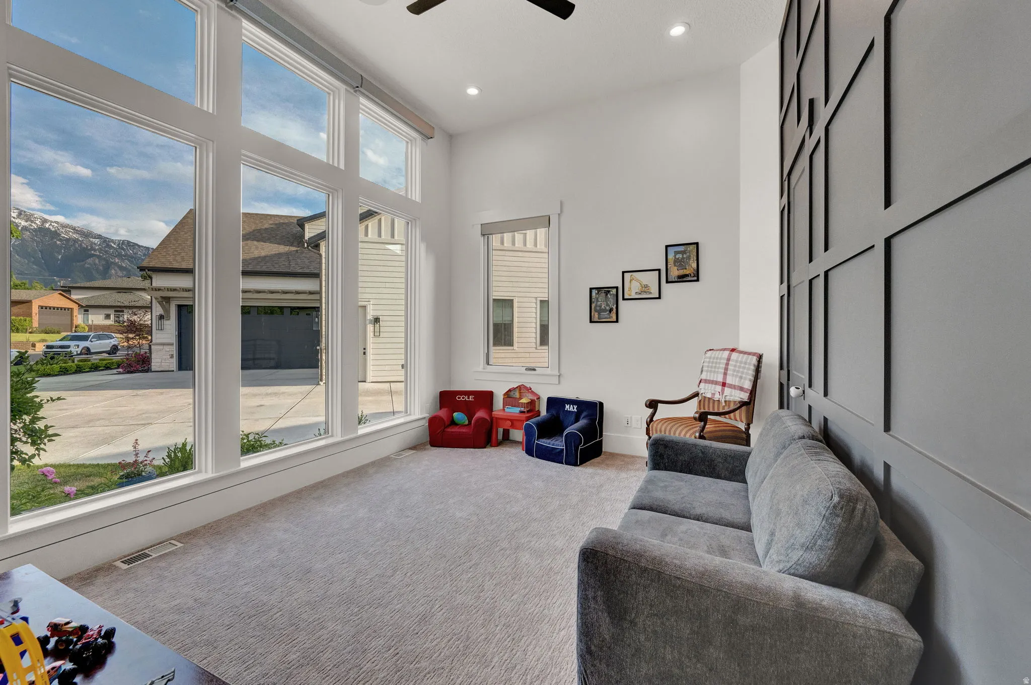 Living area with carpet, a ceiling fan, a mountain view, and recessed lighting