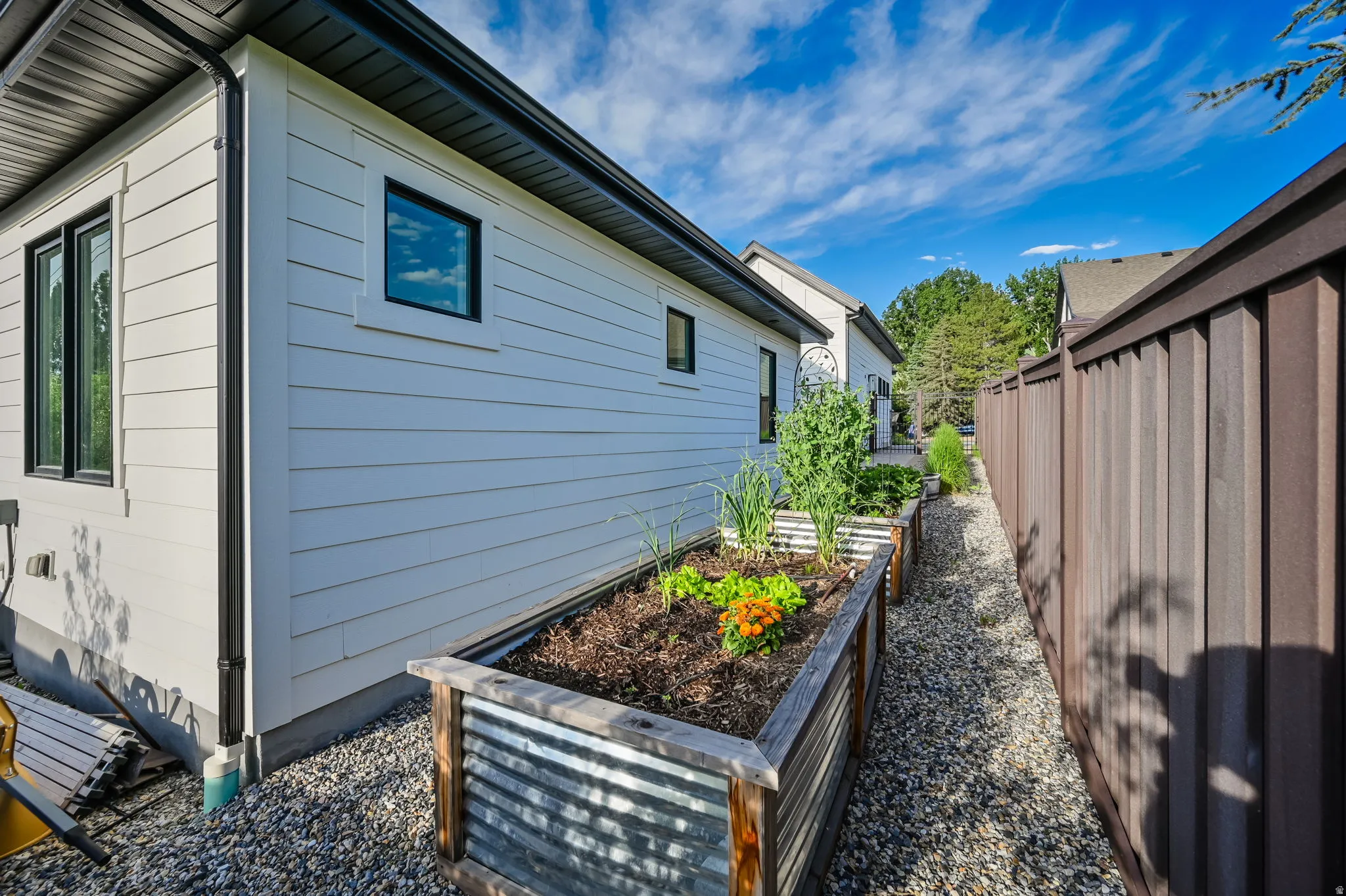 View of property exterior with a garden