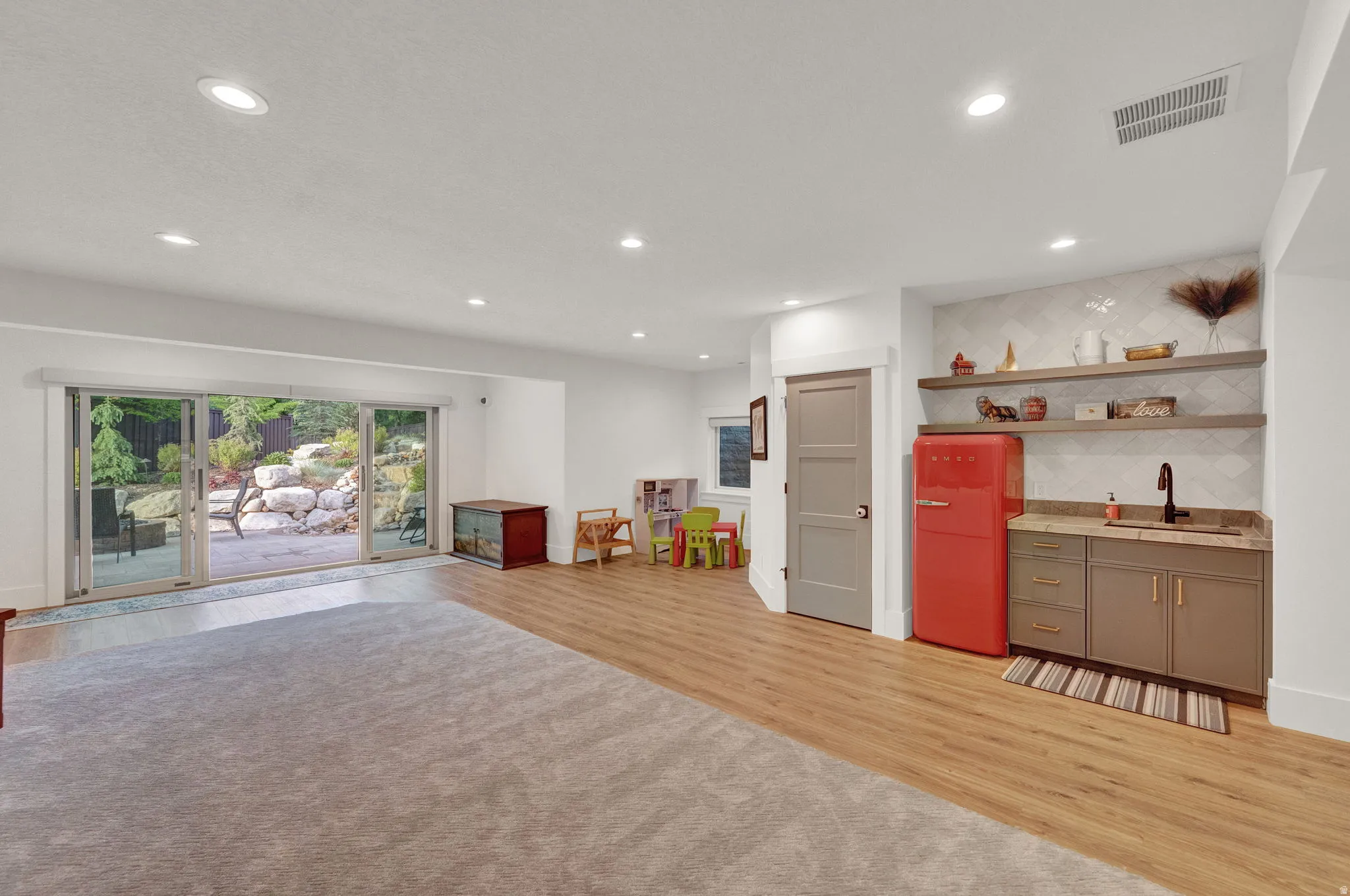 Rec room with light wood finished floors and recessed lighting