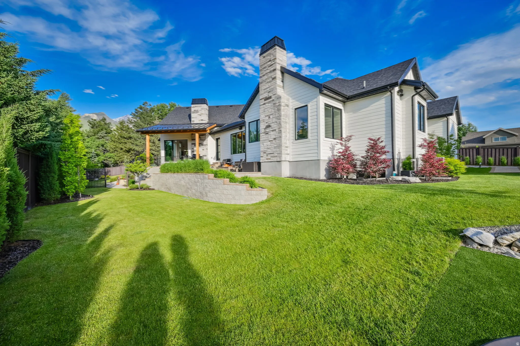 Back of house featuring a chimney and a patio