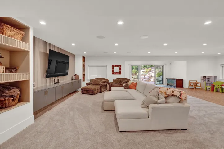 Living room with recessed lighting and built in features