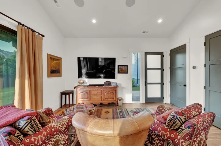 Living area featuring wood finished floors, lofted ceiling, and recessed lighting