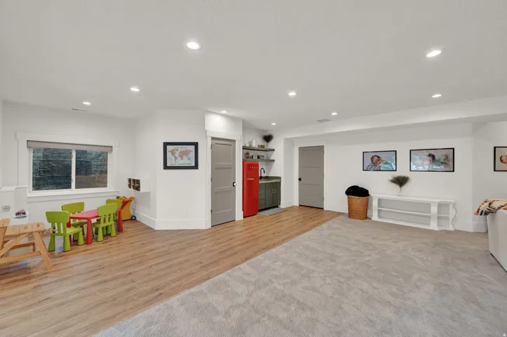 Game room featuring light wood-type flooring, recessed lighting, and light carpet