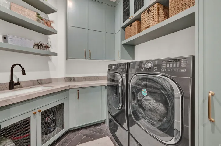 Laundry room with independent washer and dryer and cabinet space