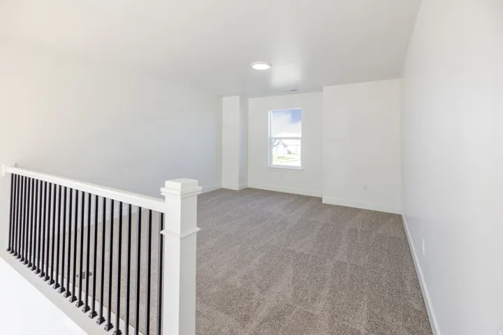 Carpeted empty room with baseboards