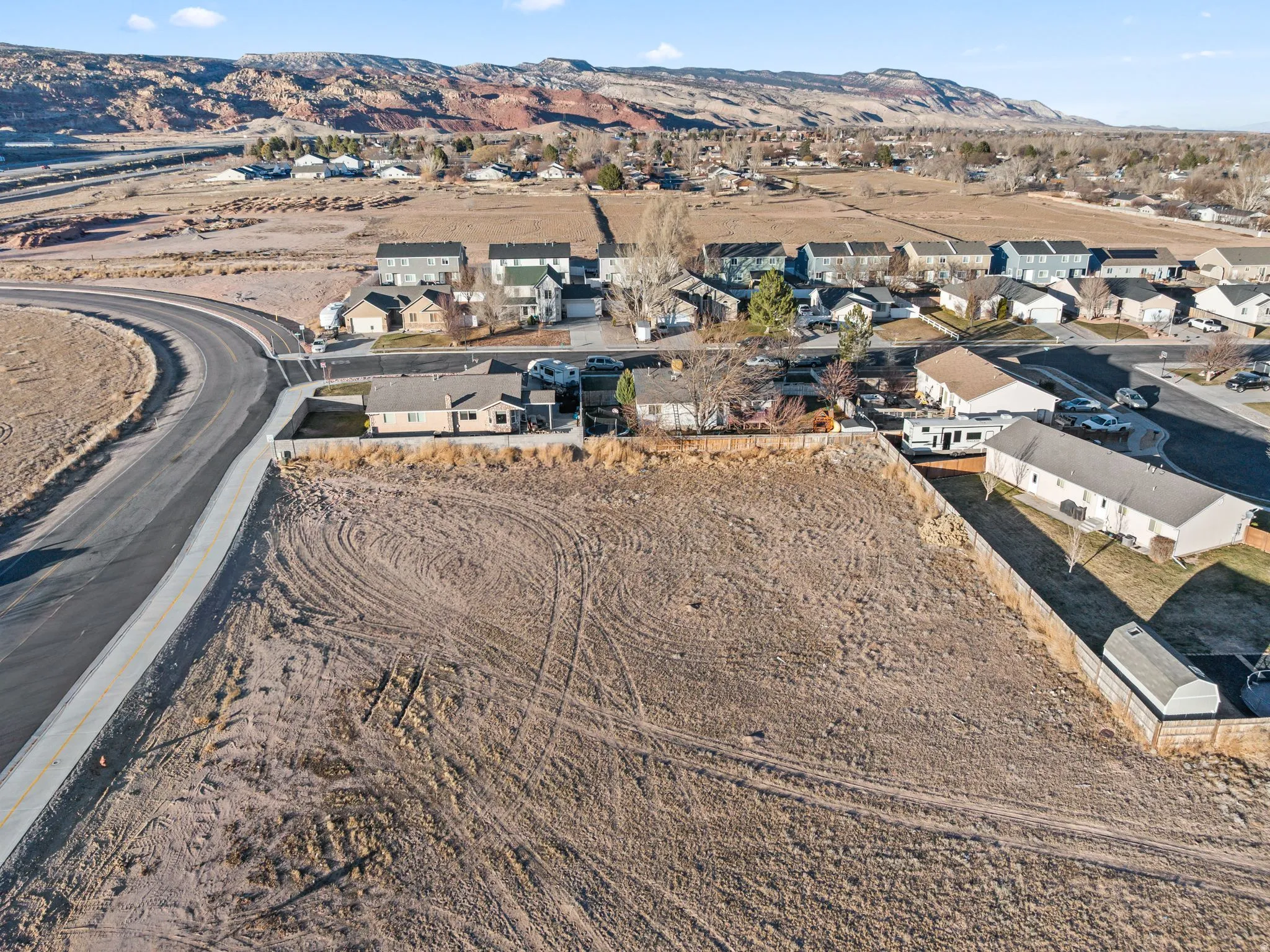Aerial overview of property's location featuring mountains and nearby suburban area