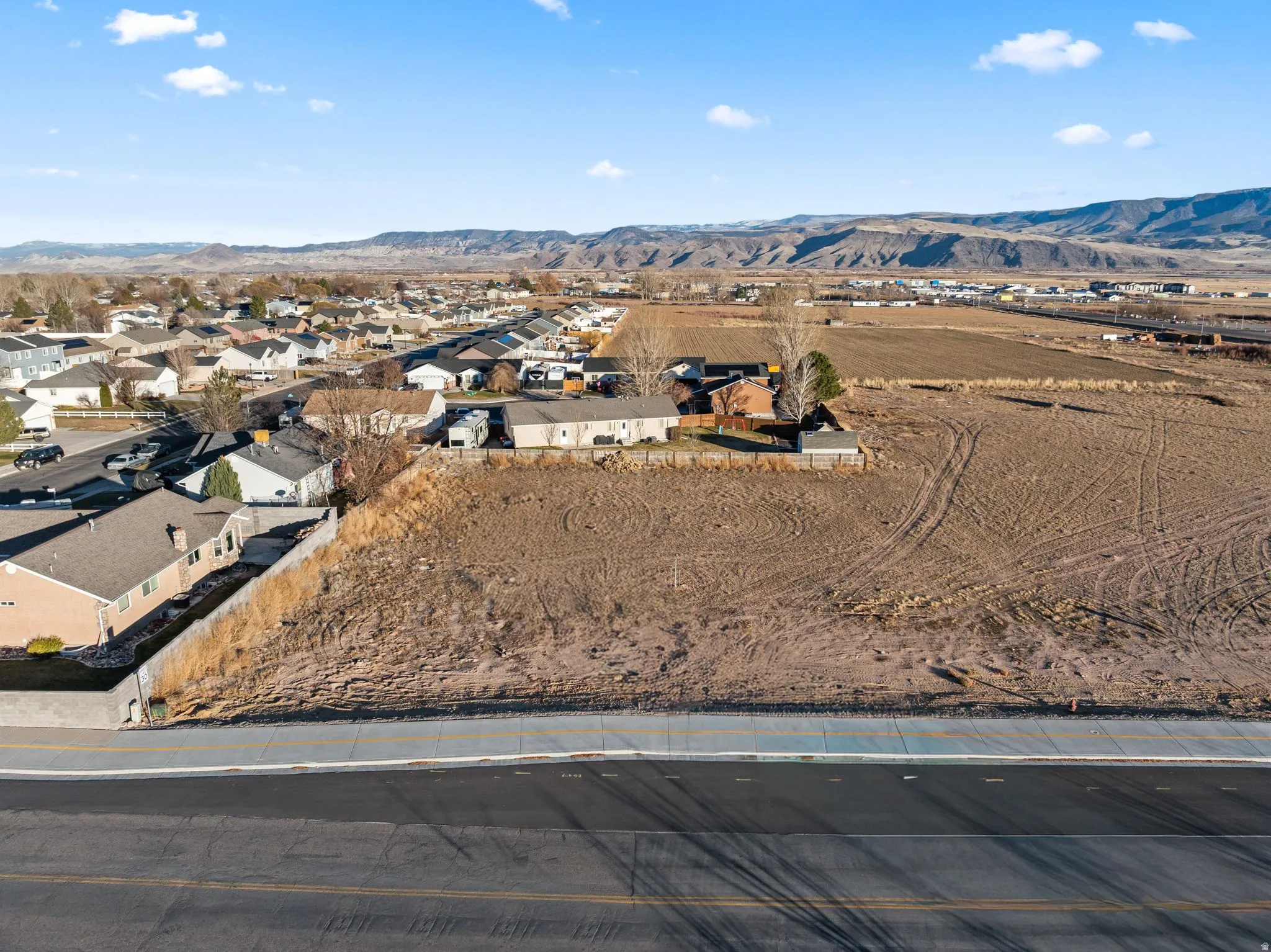 Aerial overview of property's location featuring nearby suburban area and mountains