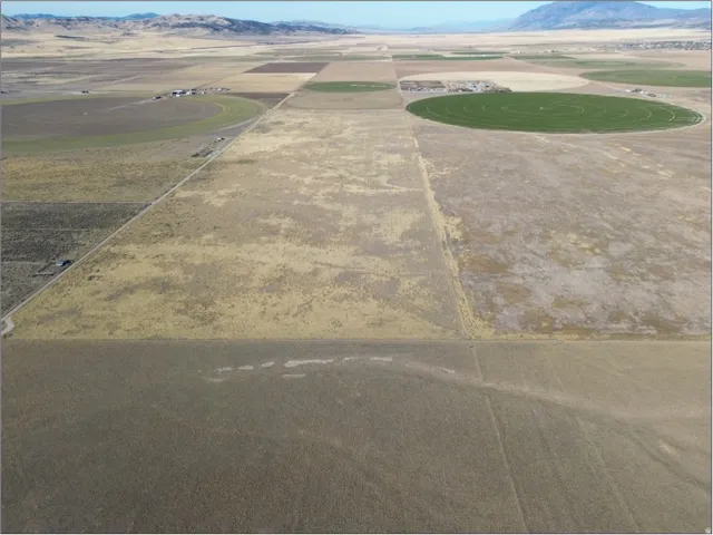 Aerial view of sparsely populated area with a mountainous background