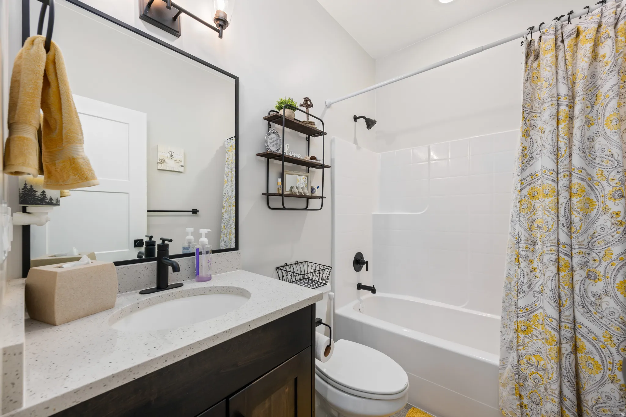 Bathroom featuring shower / bath combo with shower curtain and vanity