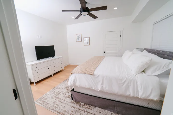 Bedroom with light wood-style flooring, a ceiling fan, and recessed lighting