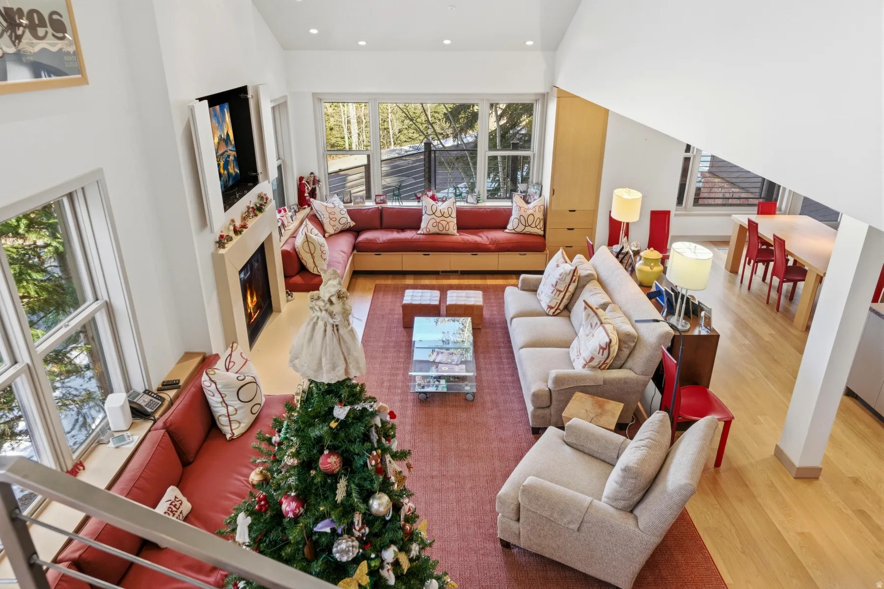Living area with light wood-style floors, a warm lit fireplace, and recessed lighting