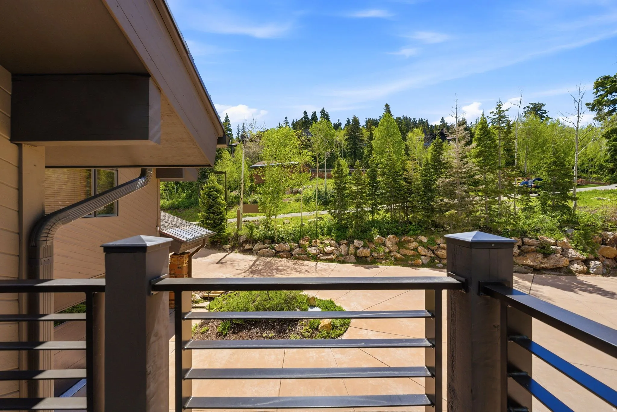 Exterior featuring a contemporary horizontal slat railing and natural wood-tone siding