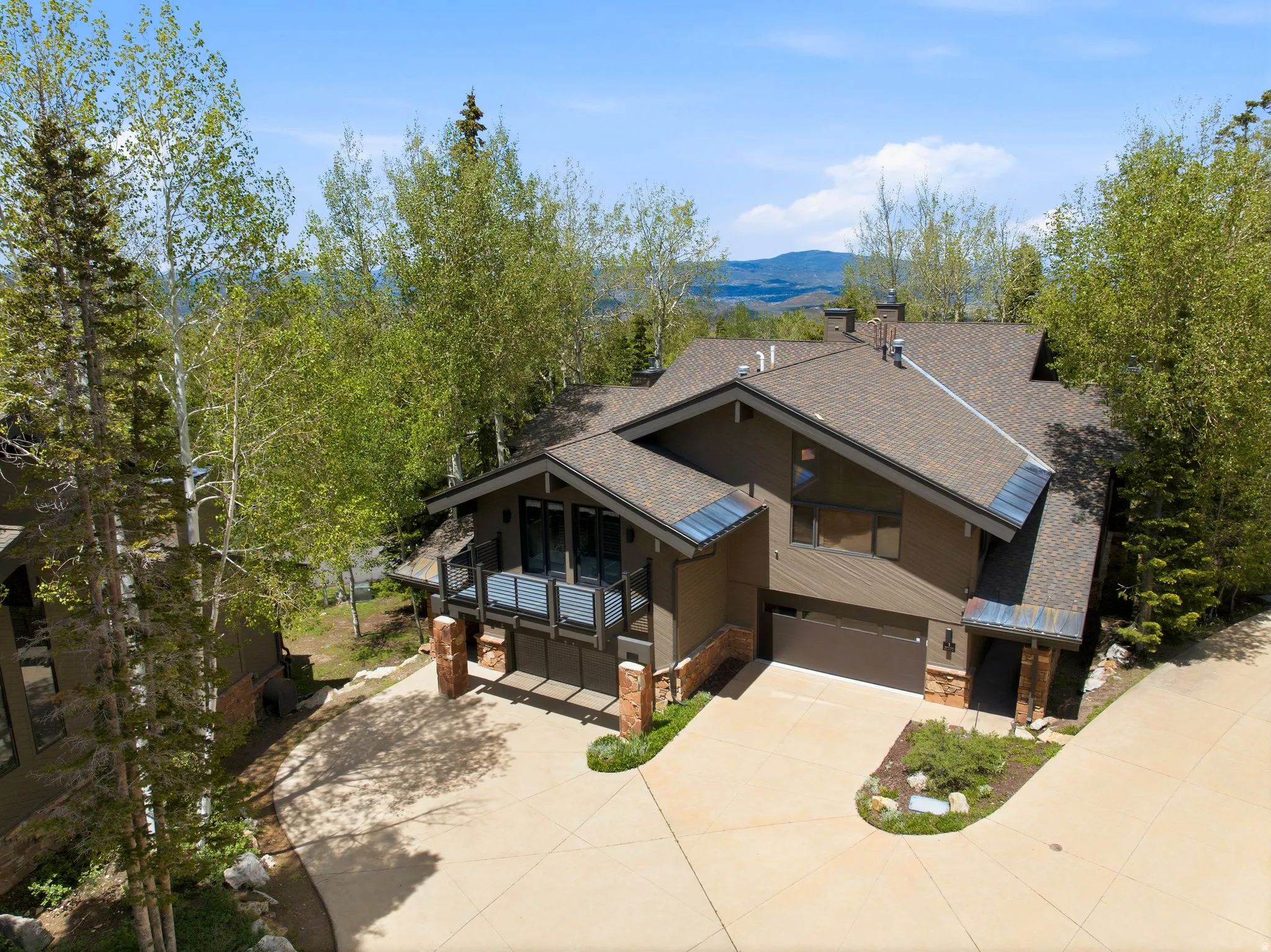 Contemporary mountain-style residence featuring a dark-toned exterior with stone accents