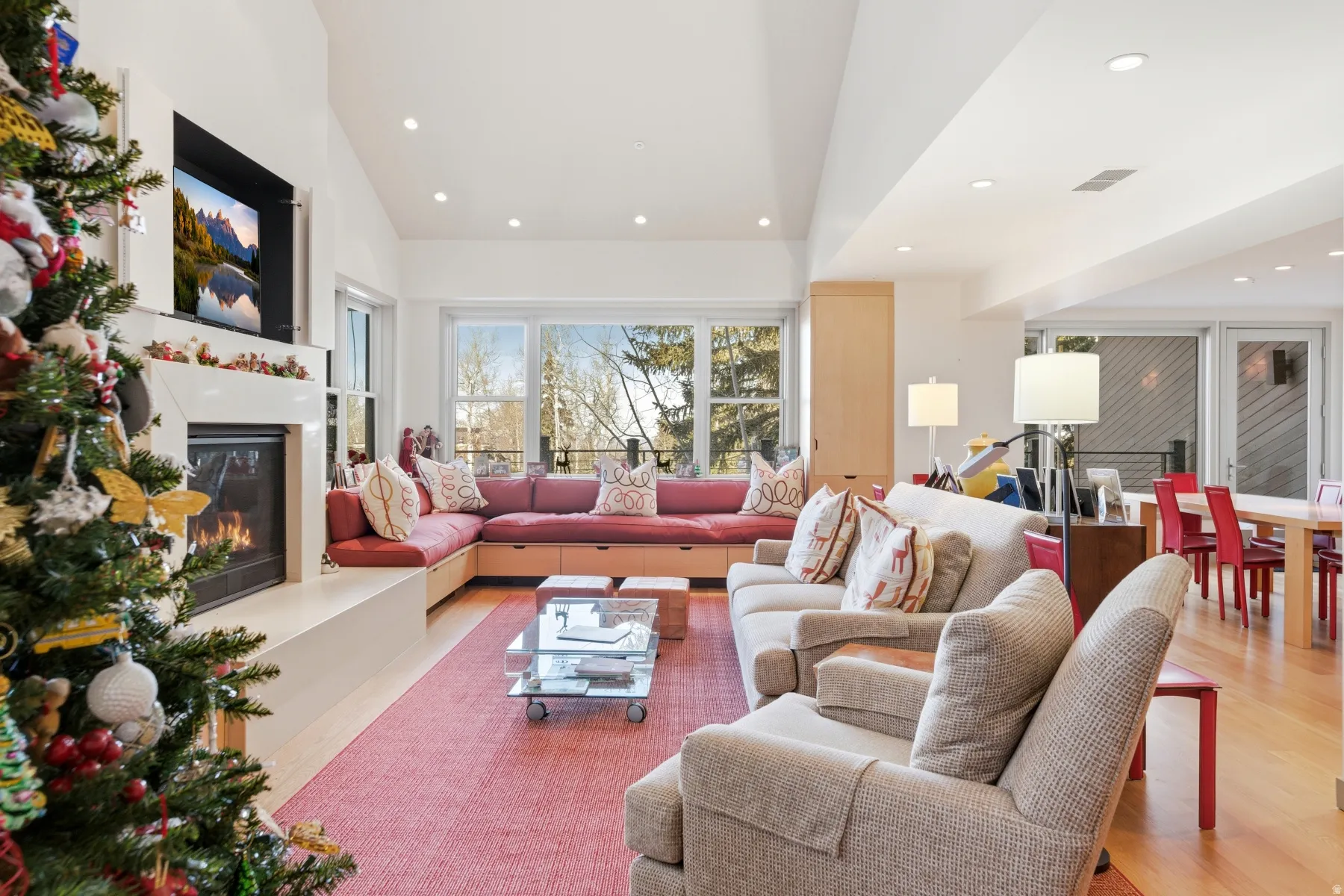 Living area featuring a glass covered fireplace, wood finished floors, and recessed lighting