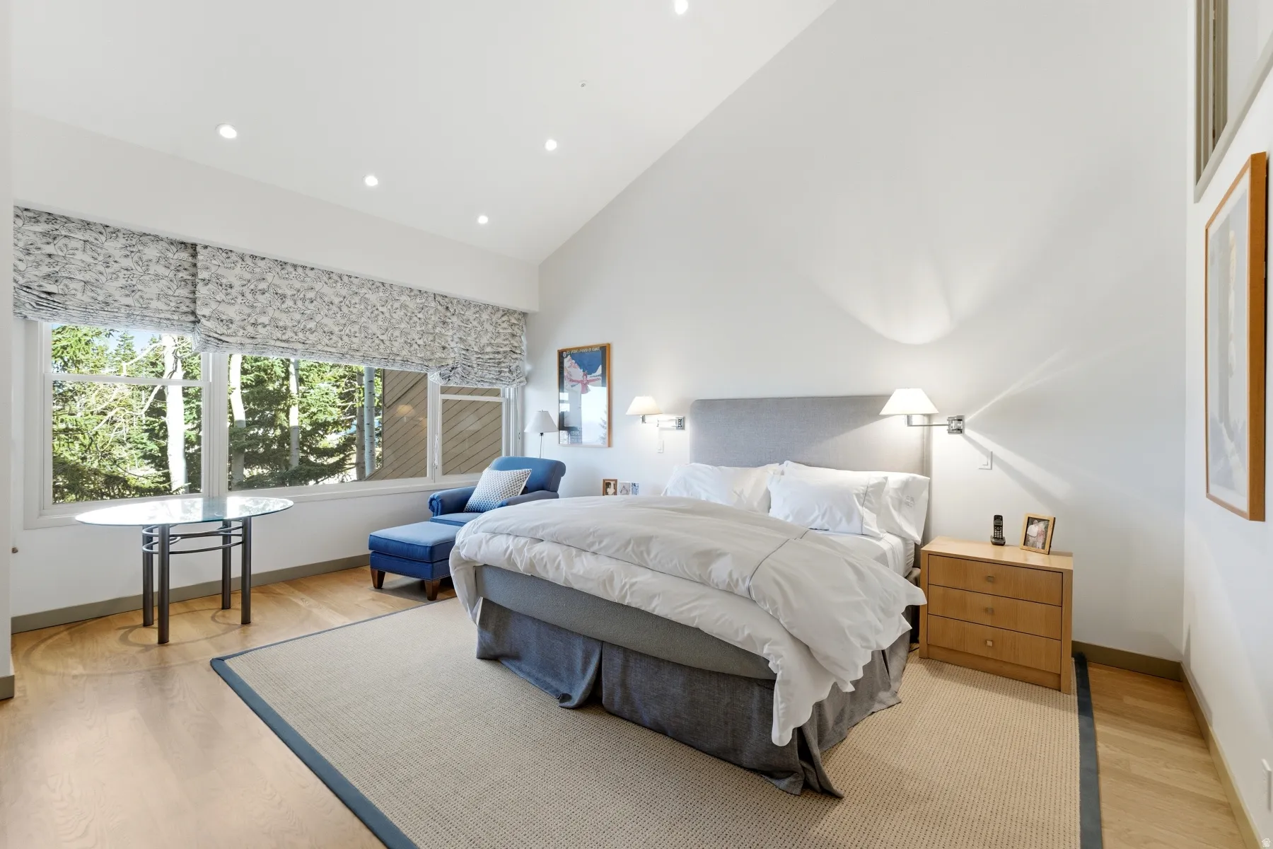 Bedroom featuring high vaulted ceiling, light wood-style floors, and recessed lighting