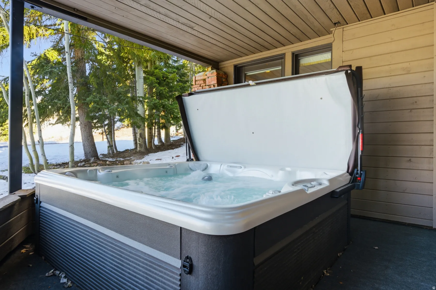 View of patio with a hot tub
