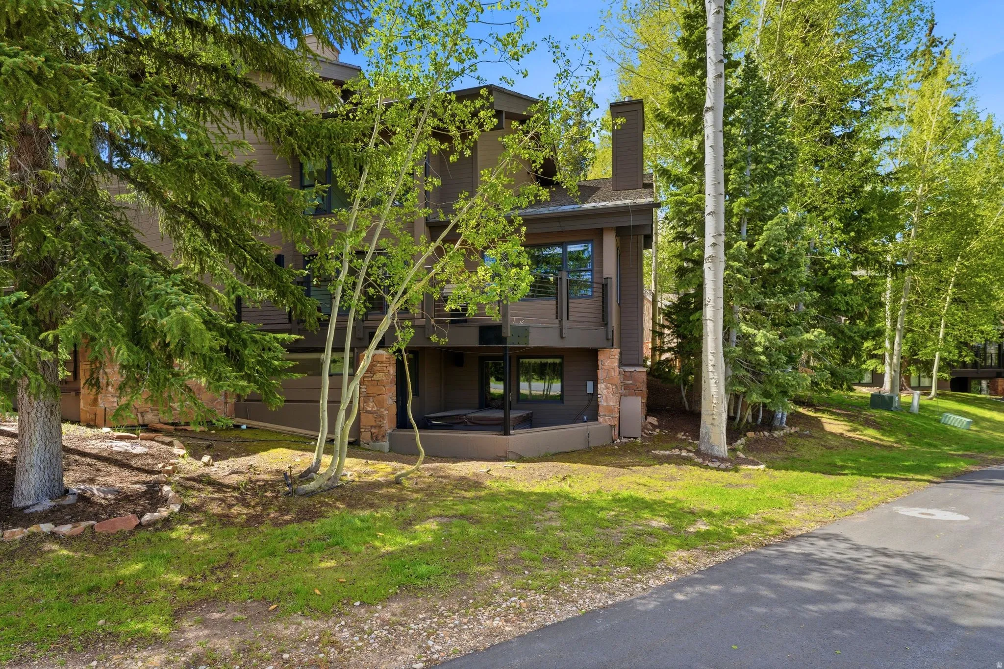 Multi-story exterior with dark siding and a prominent chimney