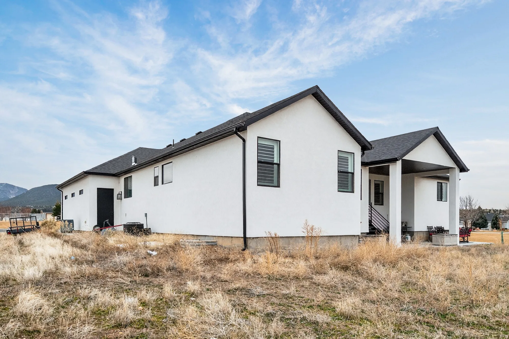 Back of house with a patio area and stucco siding