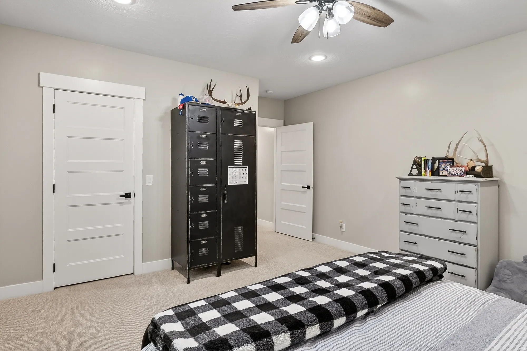 Bedroom featuring light colored carpet and a ceiling fan