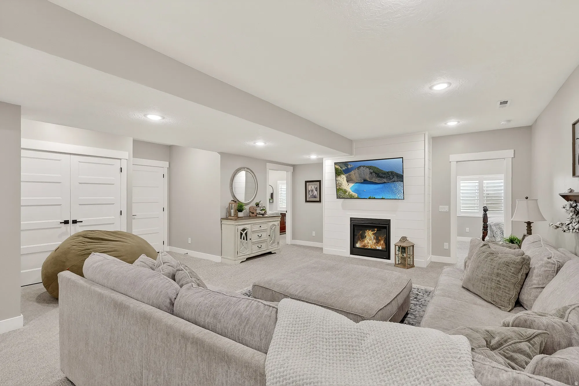 Living area featuring a fireplace, carpet, and recessed lighting