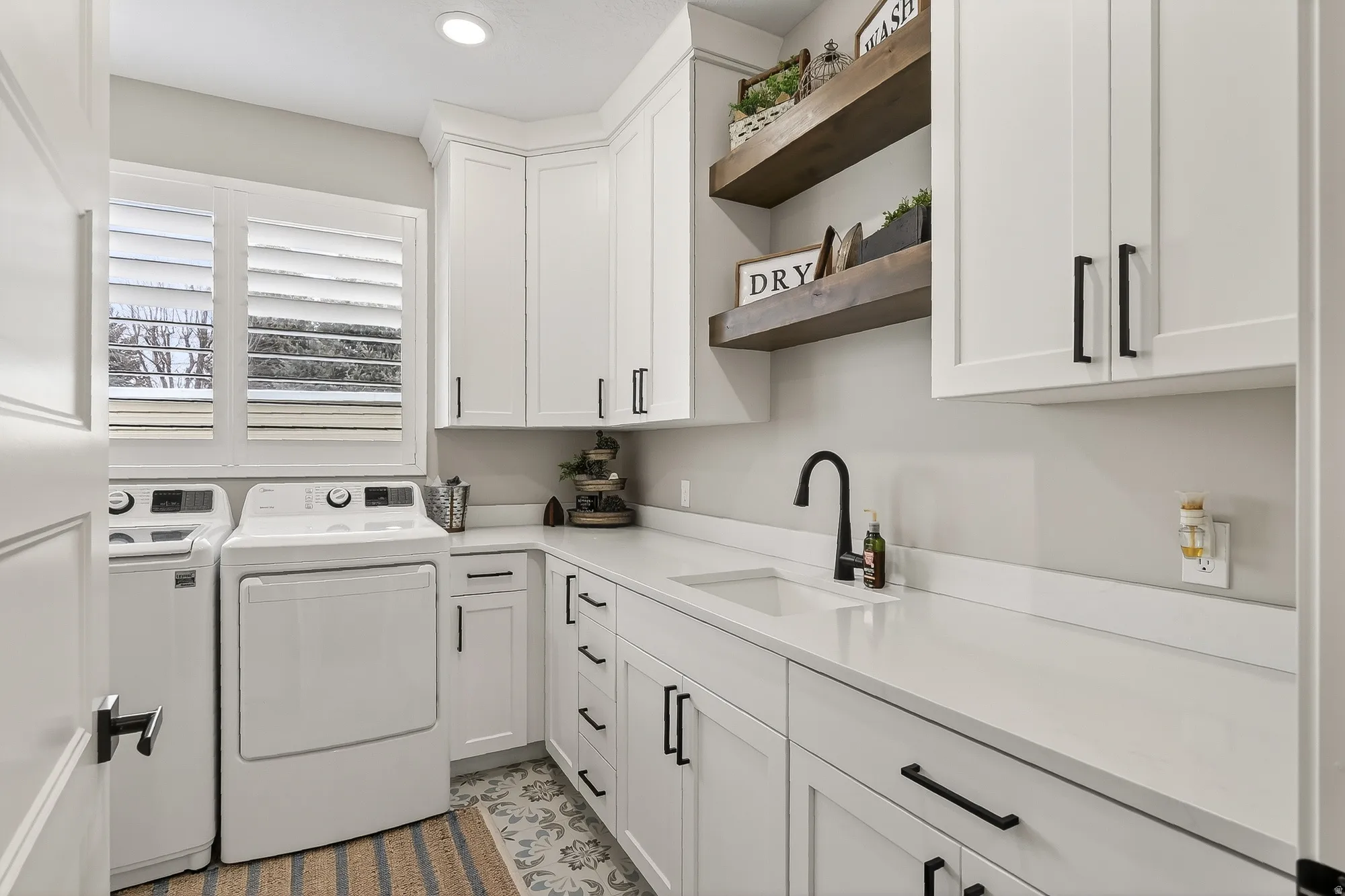 Laundry area featuring cabinet space, washing machine and dryer, and recessed lighting