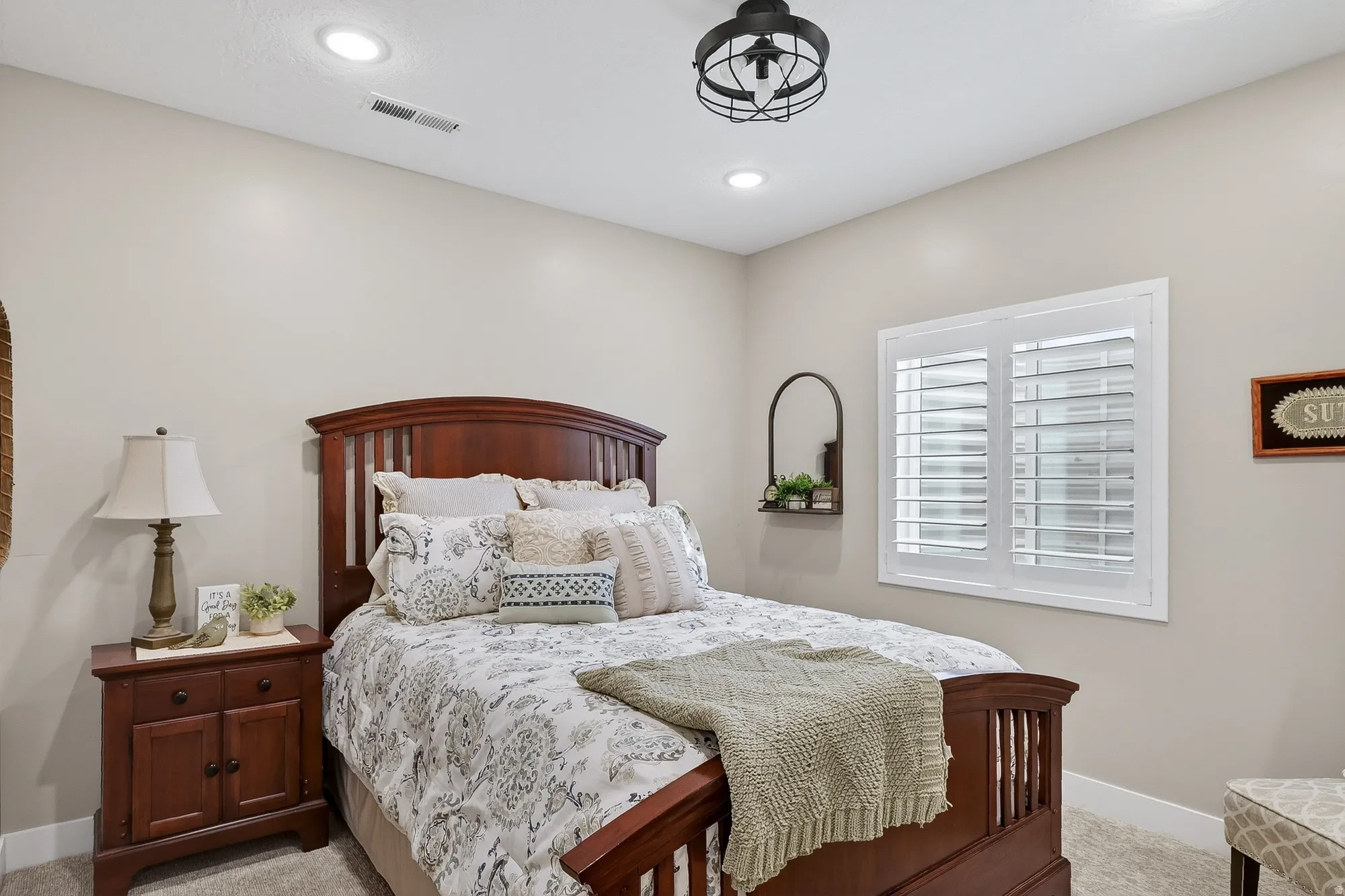 Bedroom with light colored carpet and recessed lighting