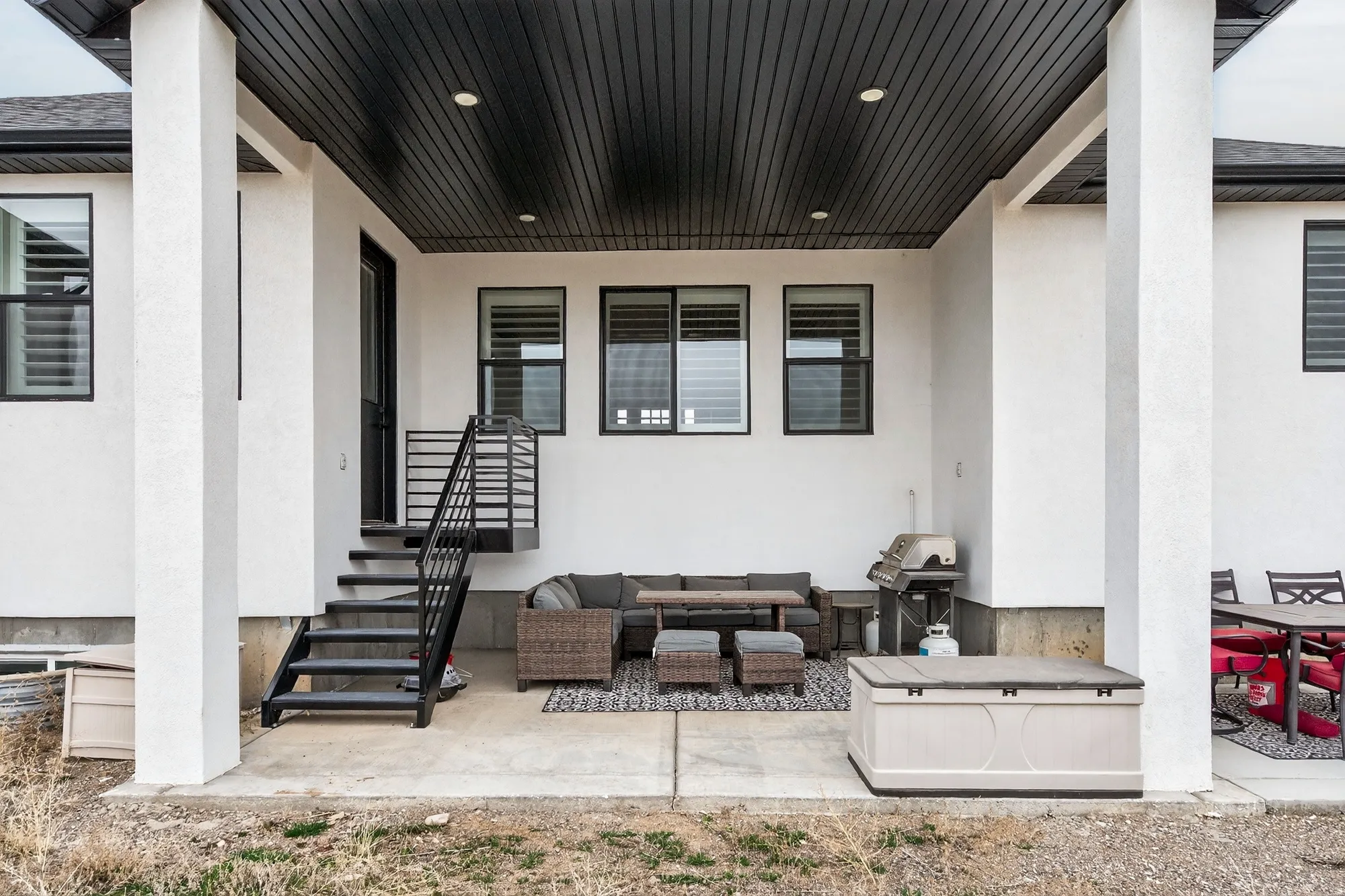 View of patio with outdoor seating and area for grilling