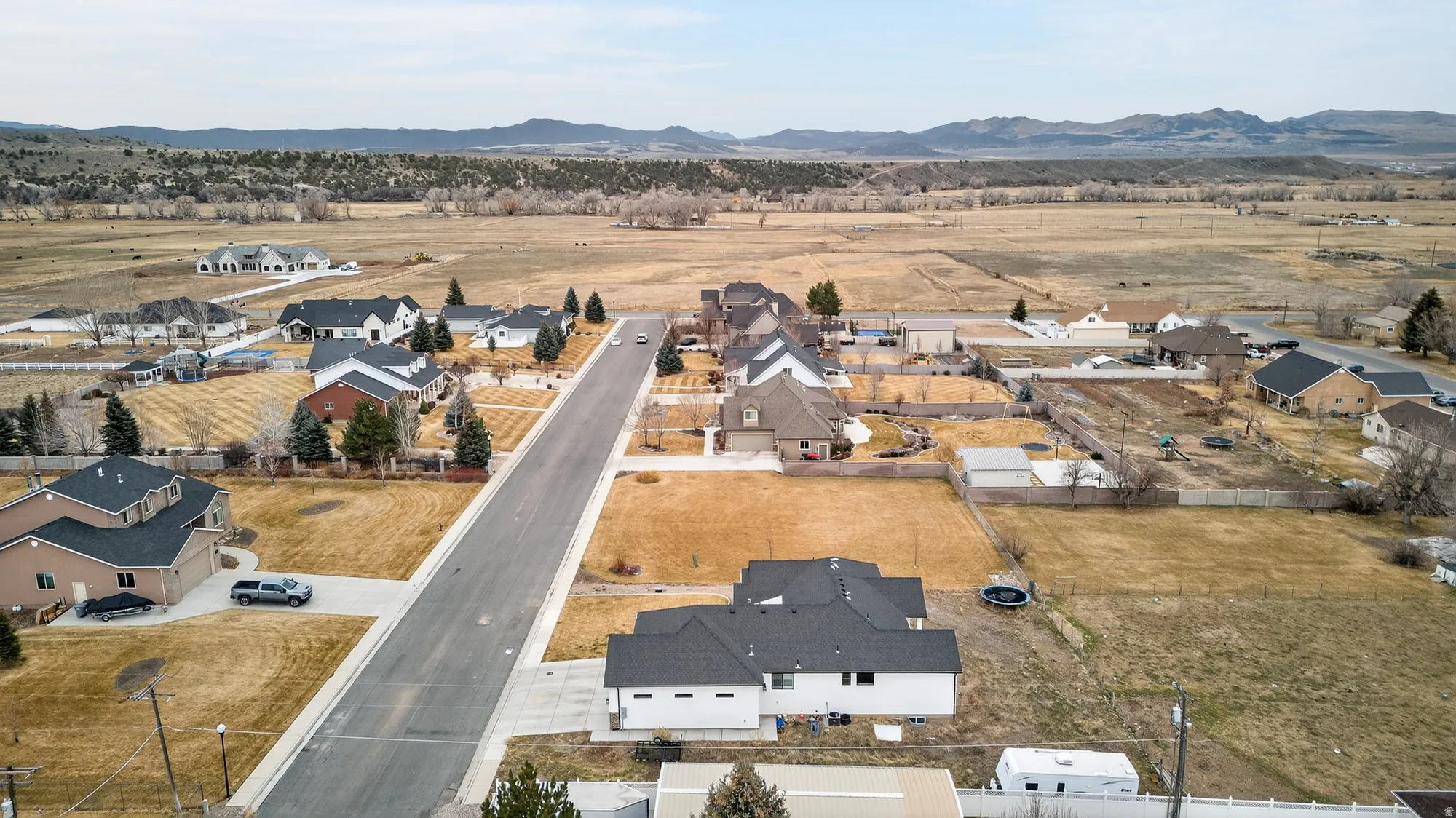 Aerial view of residential area featuring a mountainous background