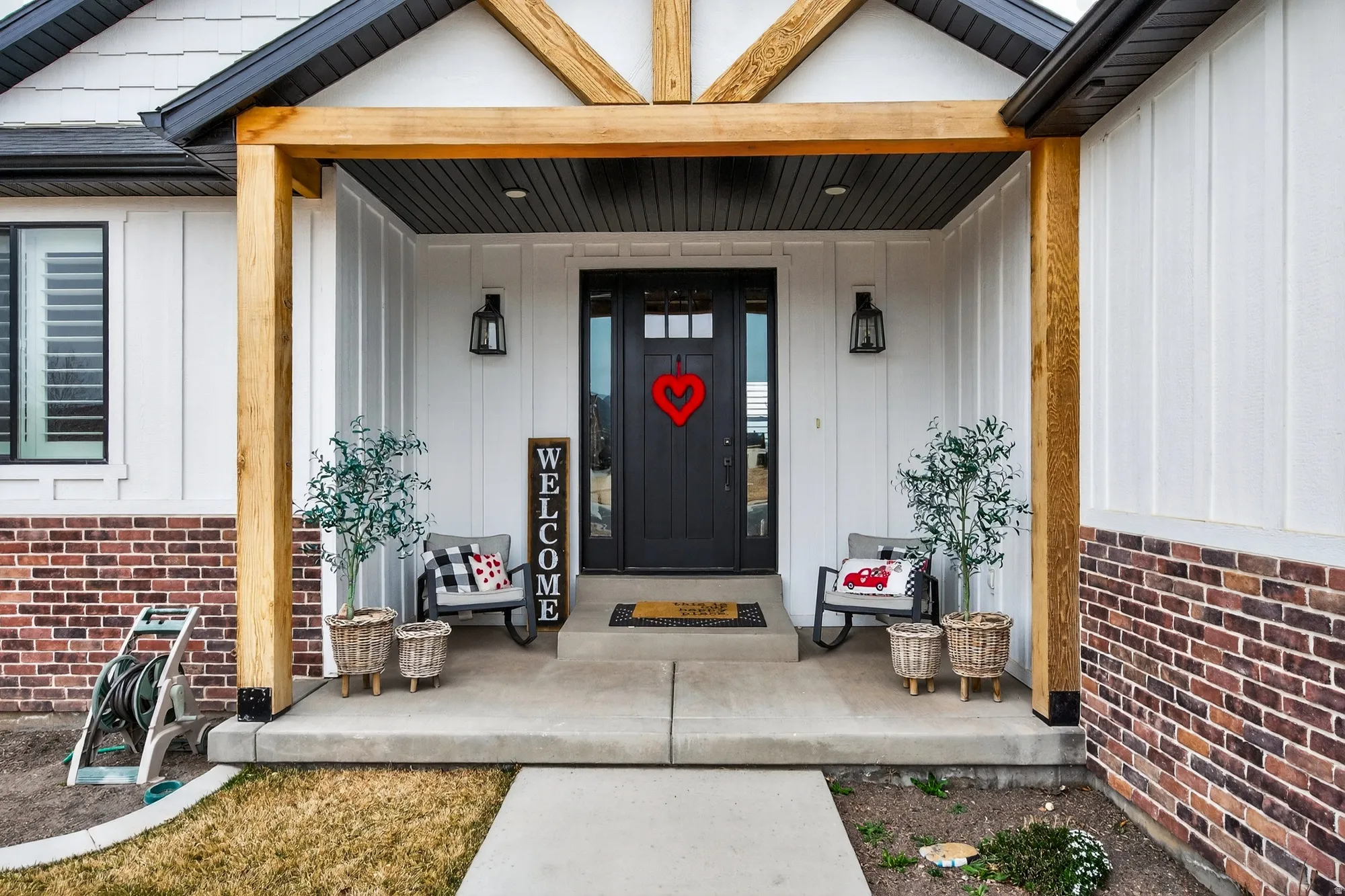 Entrance to property featuring covered porch and board and batten siding